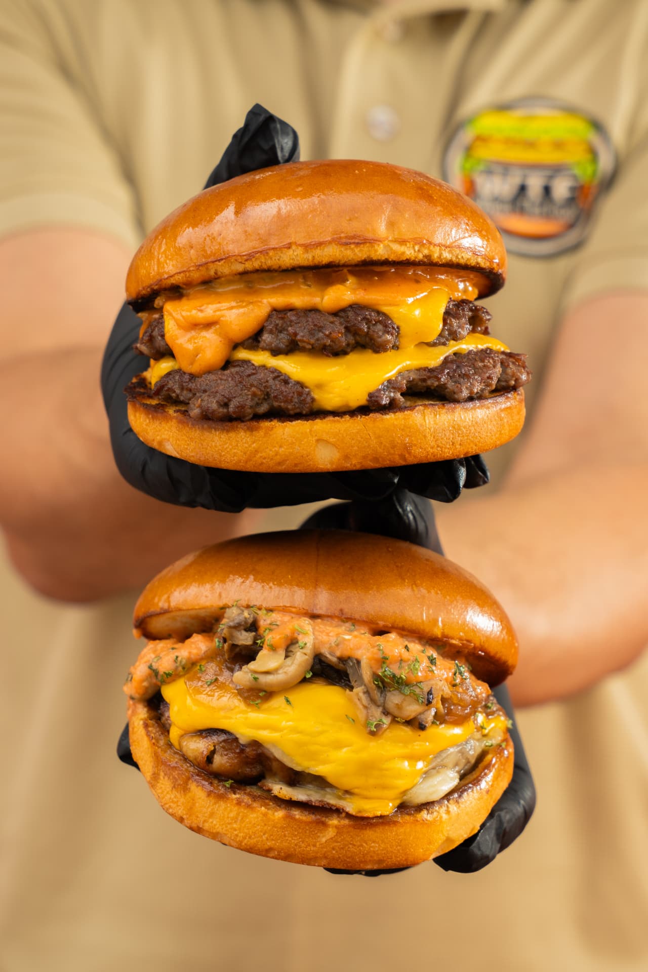 Two What's That Food! USA burgers held by a team member